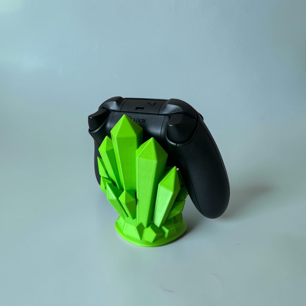 Magicland 3D green crystal controller stand holding a black Xbox controller on a white background.