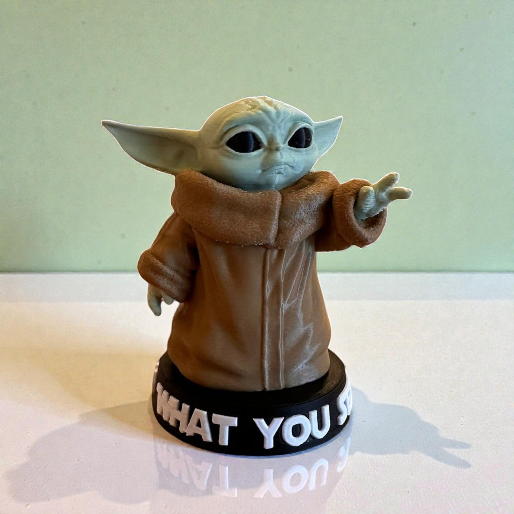 Magicland 3D Grogu figure with green skin, large ears, and brown robe, standing on a black base with white text.