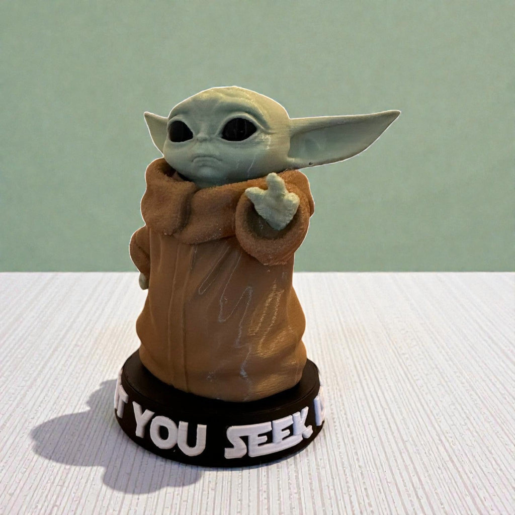 Magicland 3D Grogu figure, green character with large ears, wearing a brown robe, standing on a black base with white text.