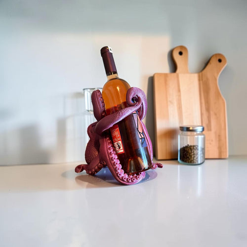 Magicland 3D purple octopus wine bottle holder, detailed tentacles grip a wine bottle.
