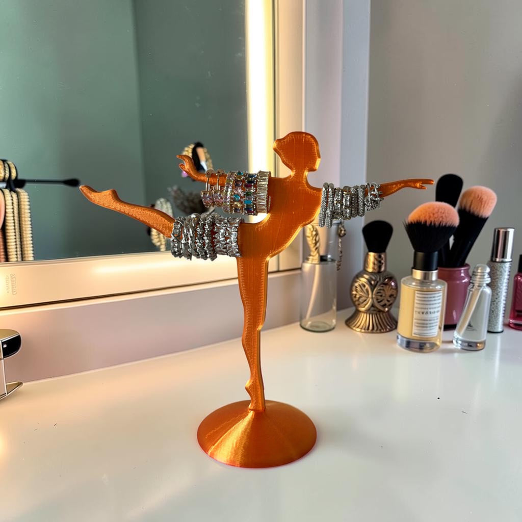 Magicland 3D orange ballerina jewelry stand holding bracelets and rings. Decorative and functional.