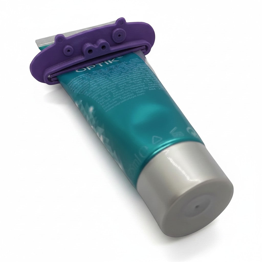 Magicland 3D purple pig-shaped toothpaste squeezer attached to a teal and silver tube.