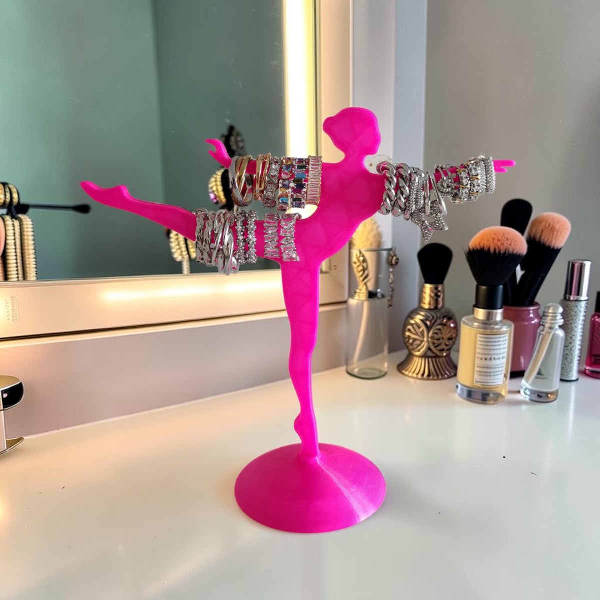 Magicland 3D hot pink ballerina jewelry stand holding bracelets and rings. Features a dancer in a pose with arms outstretched.