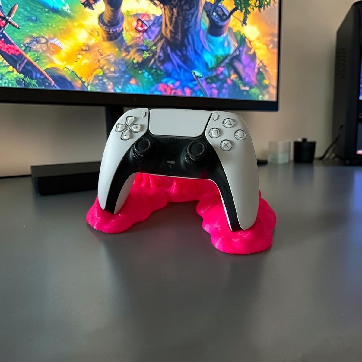 Magicland 3D white and black game controller resting on a bright pink, sticky-effect stand against a white background.