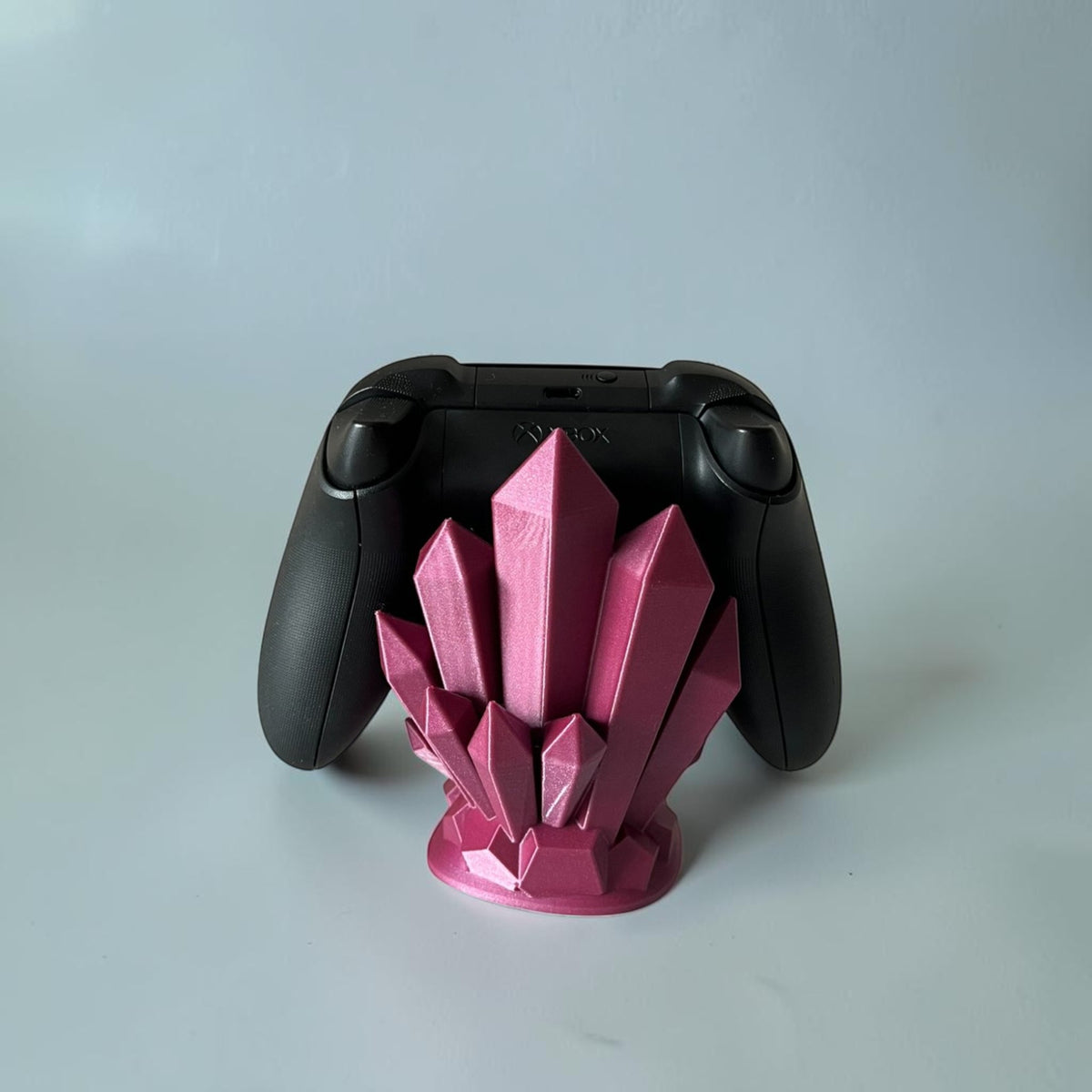 Magicland 3D pink crystal controller stand holding an Xbox controller. Decorative gaming accessory.