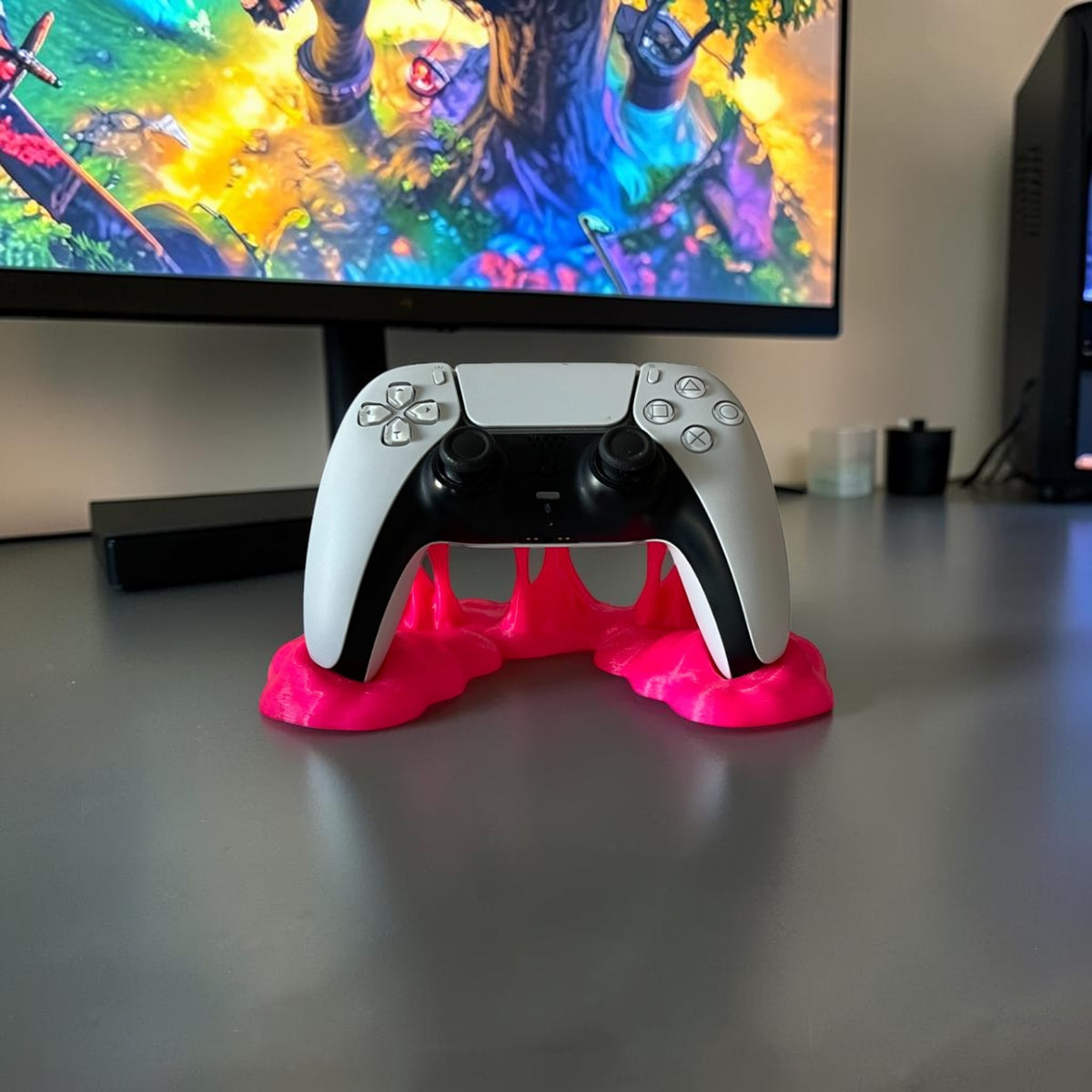 Magicland 3D white PS5 controller resting on a bright pink, slime-effect stand.