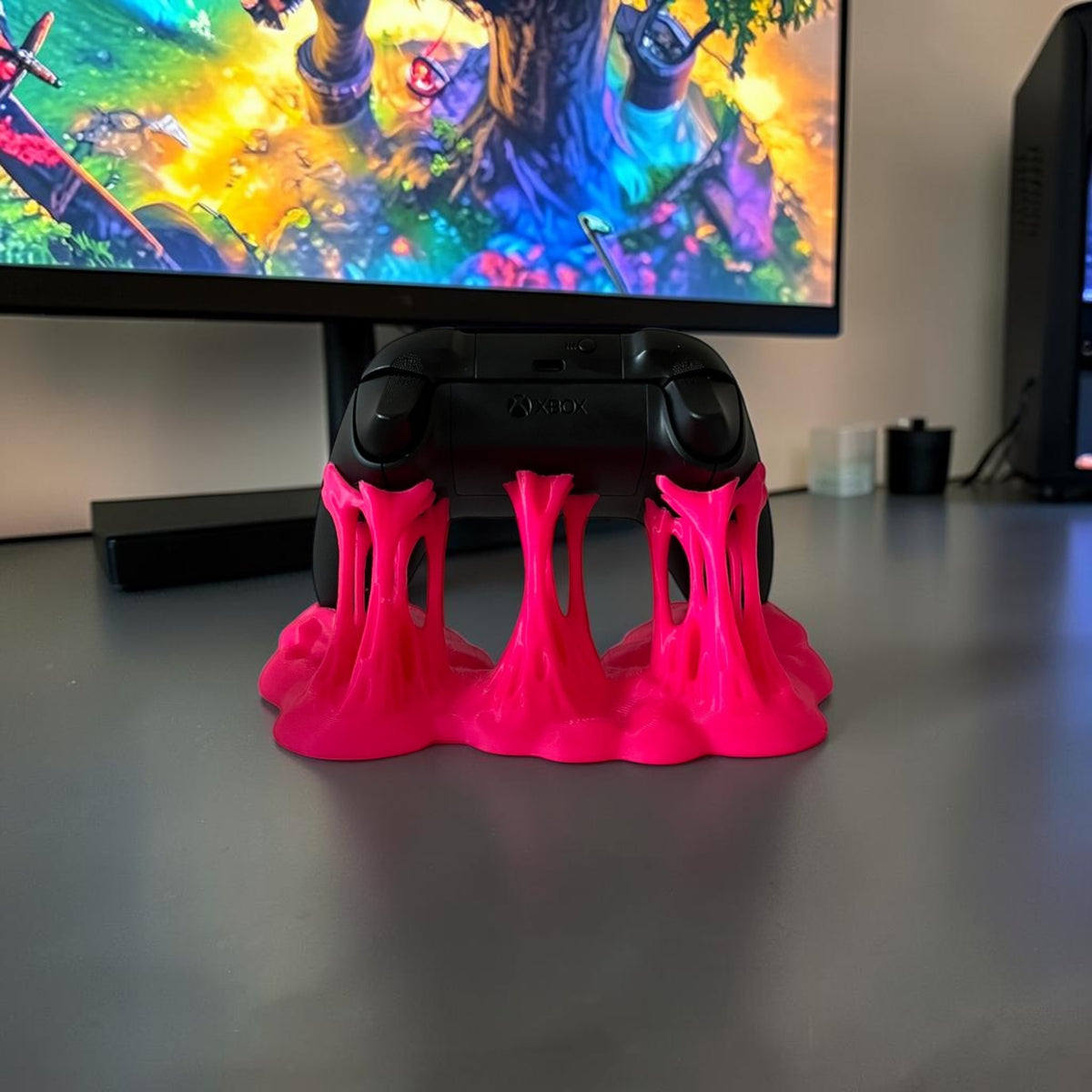Magicland 3D pink slime-effect controller stand holding an Xbox controller.
