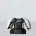 Magicland 3D black PS5 controller stand with PlayStation logo, holding a white PS5 controller.