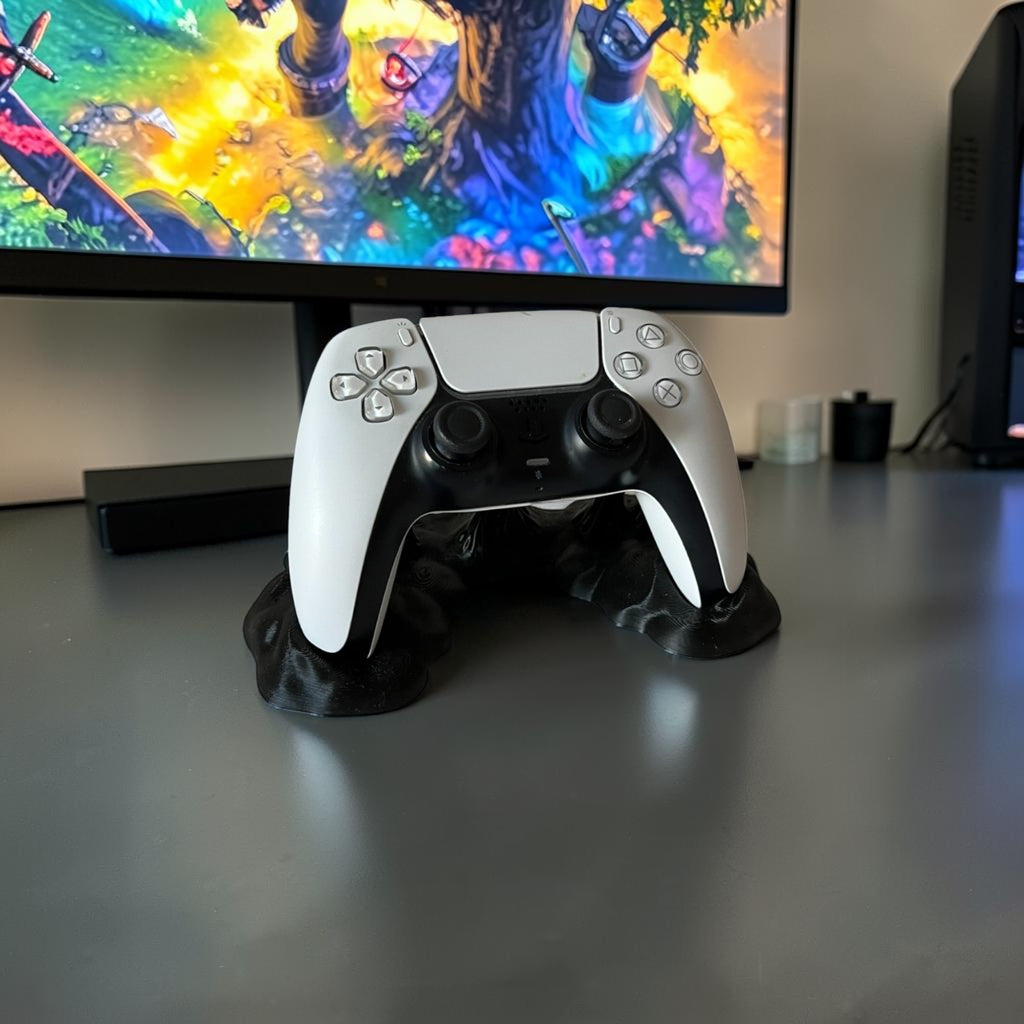 Magicland 3D black melting effect stand holding a white and black PlayStation 5 controller.