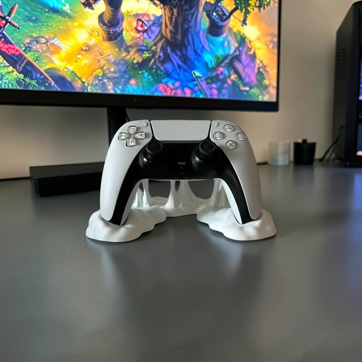Magicland 3D white decorative stand with a sticky effect holding a white PlayStation 5 controller.
