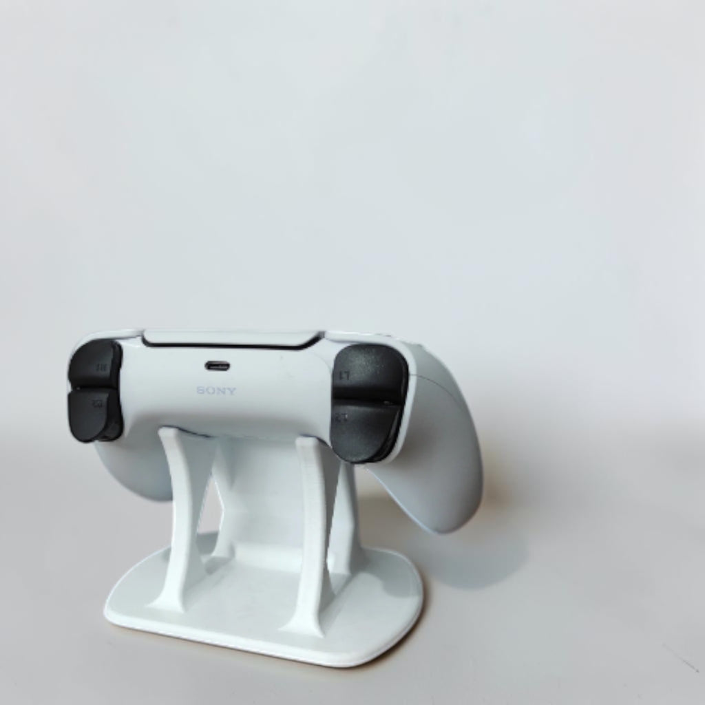Magicland 3D white PS5 controller stand with PlayStation 5 console in background.