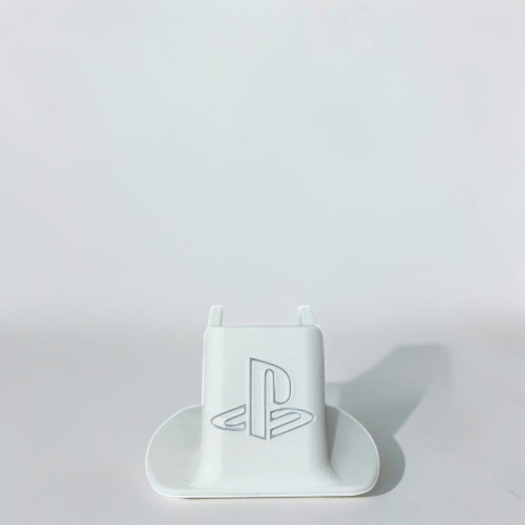Magicland 3D white PS5 controller stand with embossed PlayStation logo, ideal for organizing gaming setups.