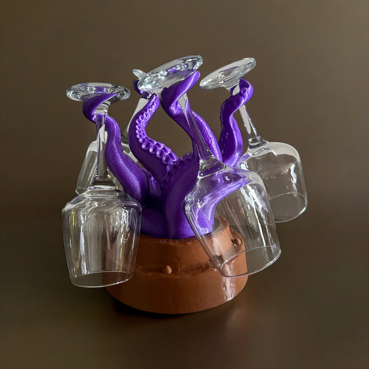 Magicland 3D purple octopus wine glass holder with brown base, holding four clear wine glasses.