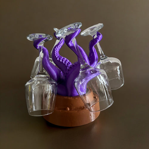 Magicland 3D purple octopus wine glass holder with brown base, holding four clear wine glasses.