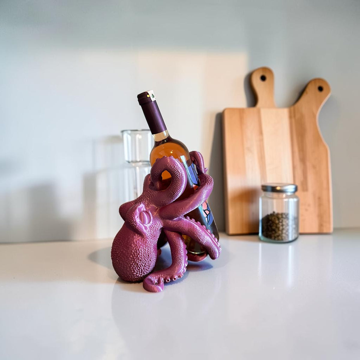 Magicland 3D purple octopus wine bottle holder, a unique and quirky accessory for your kitchen or bar.
