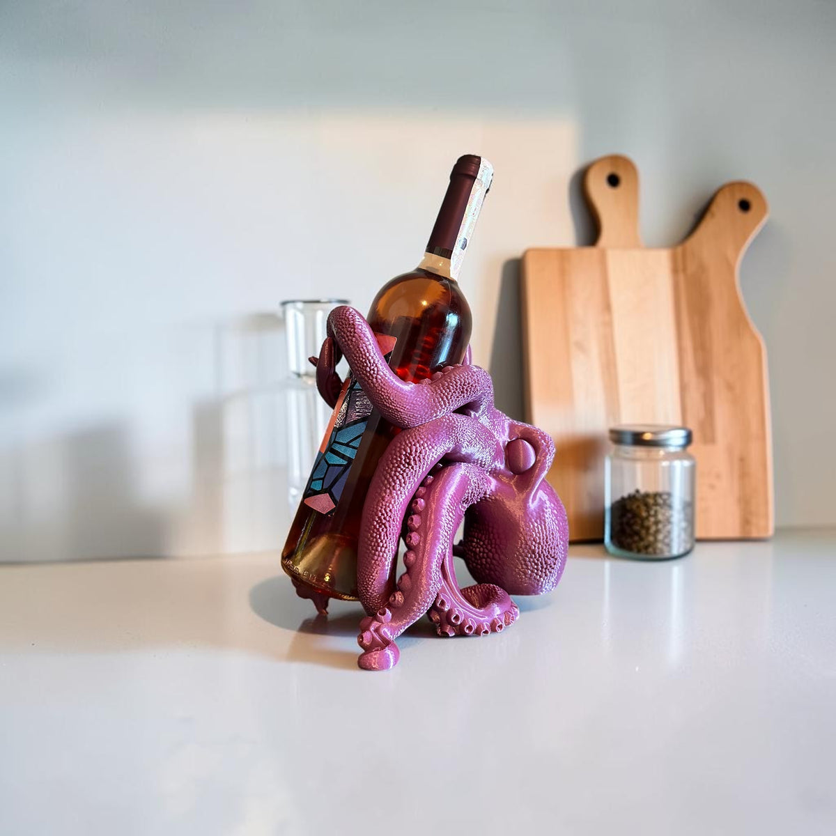 Magicland 3D purple octopus wine bottle holder with textured tentacles gripping a rose wine bottle.