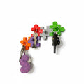 Magicland 3D colourful puzzle piece key holder with hooks for keys and a purple seahorse charm.