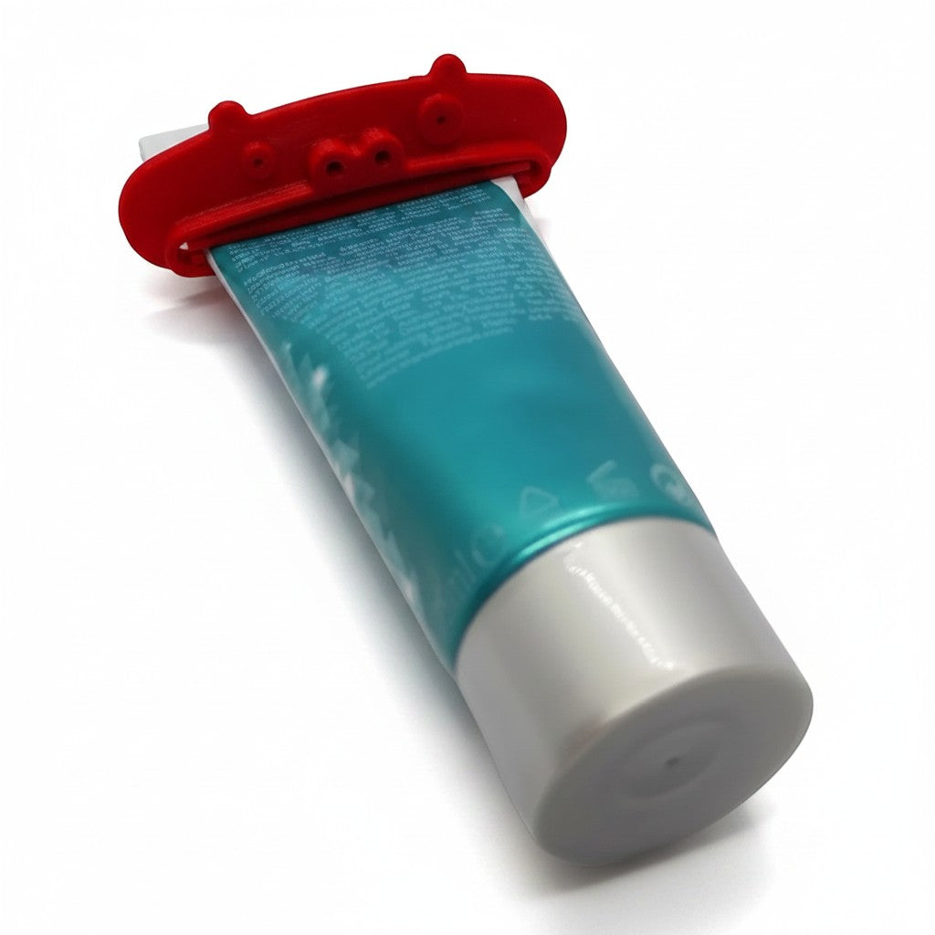 Magicland 3D red pig-shaped toothpaste squeezer attached to a teal and white toothpaste tube.
