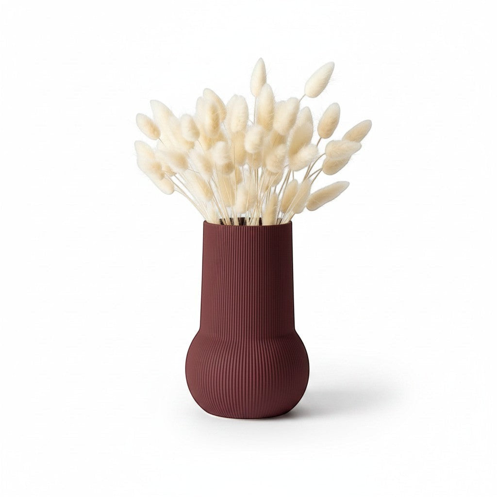 Magicland 3D decorative vase in a deep red, ribbed texture, holding dried bunny tail grass.