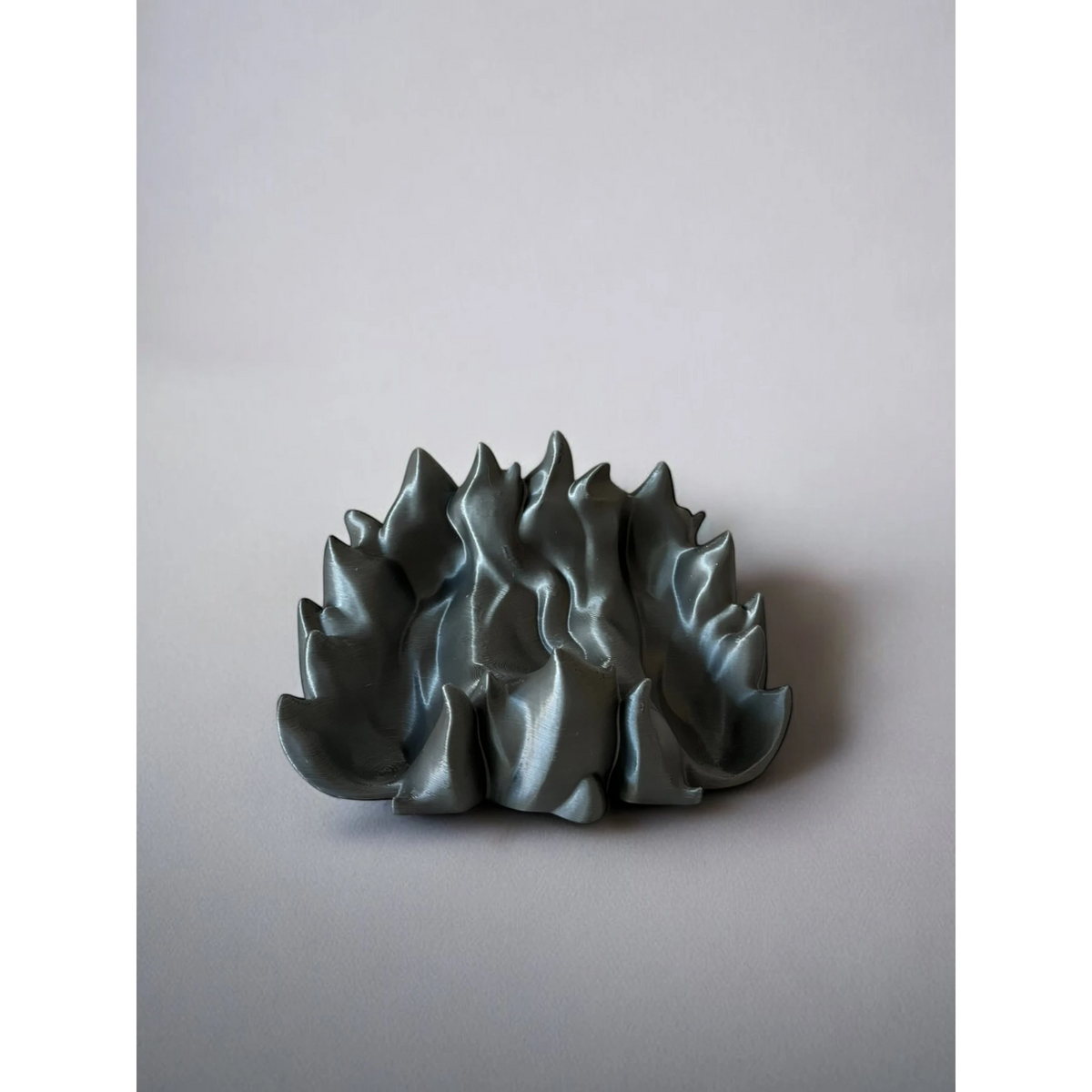 Magicland 3D silver flame-shaped phone stand, 3D printed.