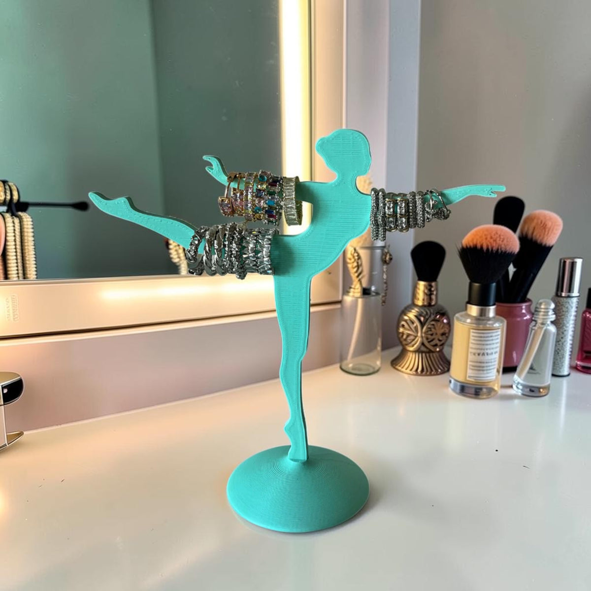 Magicland 3D turquoise ballerina jewelry stand holding bracelets and rings. Decorative display for accessories.