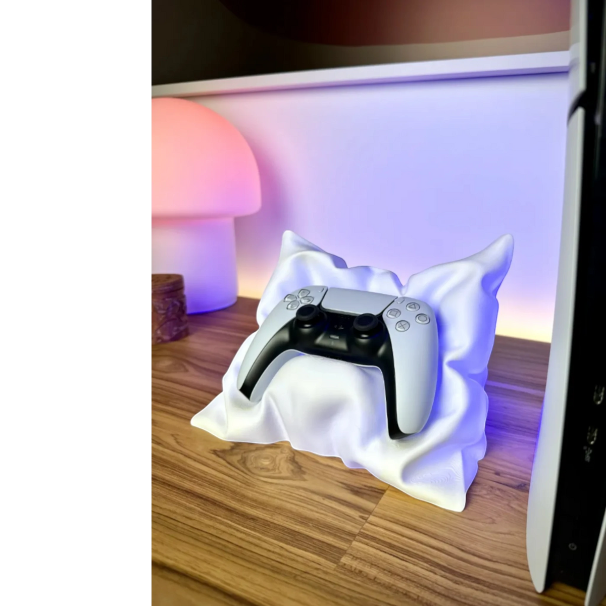 Magicland 3D white pillow-shaped stand holding a white PlayStation 5 controller on a wooden surface.