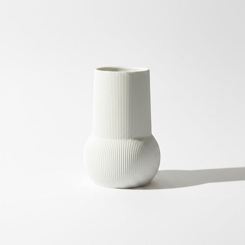 Magicland 3D white ribbed ceramic decorative vase with a rounded base and cylindrical top.