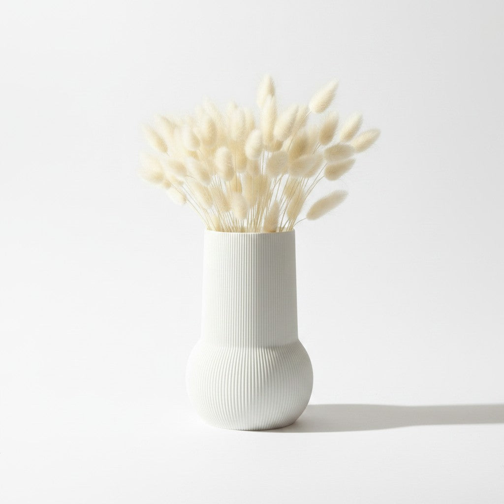 Magicland 3D white ribbed ceramic vase with dried bunny tail grass on a wooden dresser.