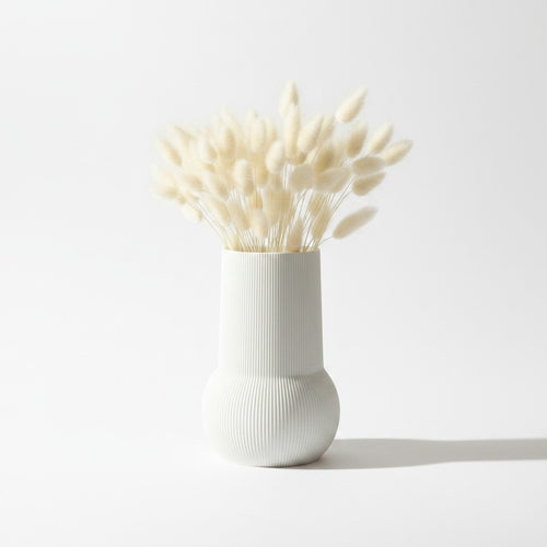 Magicland 3D white ribbed ceramic vase with dried bunny tail grass on a wooden dresser.