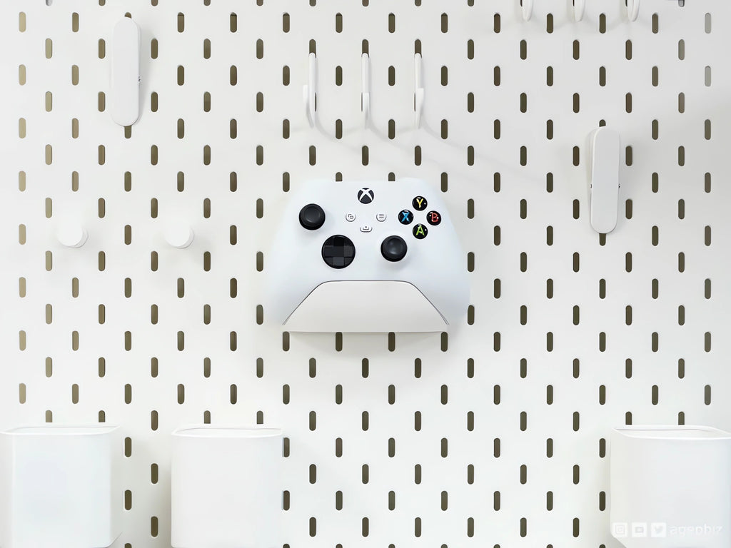 Magicland 3D white Xbox controller holder mounted on a white pegboard with hooks and containers.