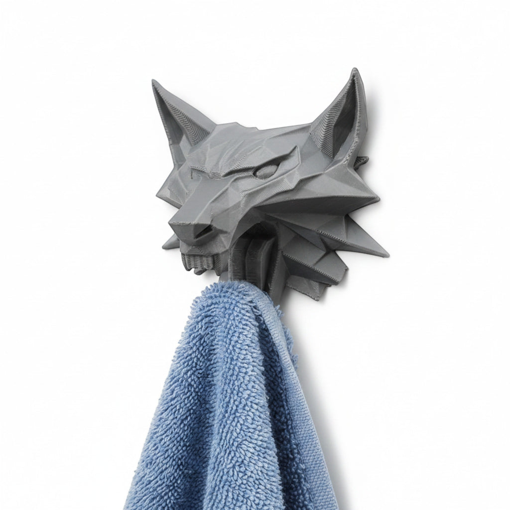 Magicland 3D grey wolf head wall hook holding a blue towel, inspired by The Witcher.