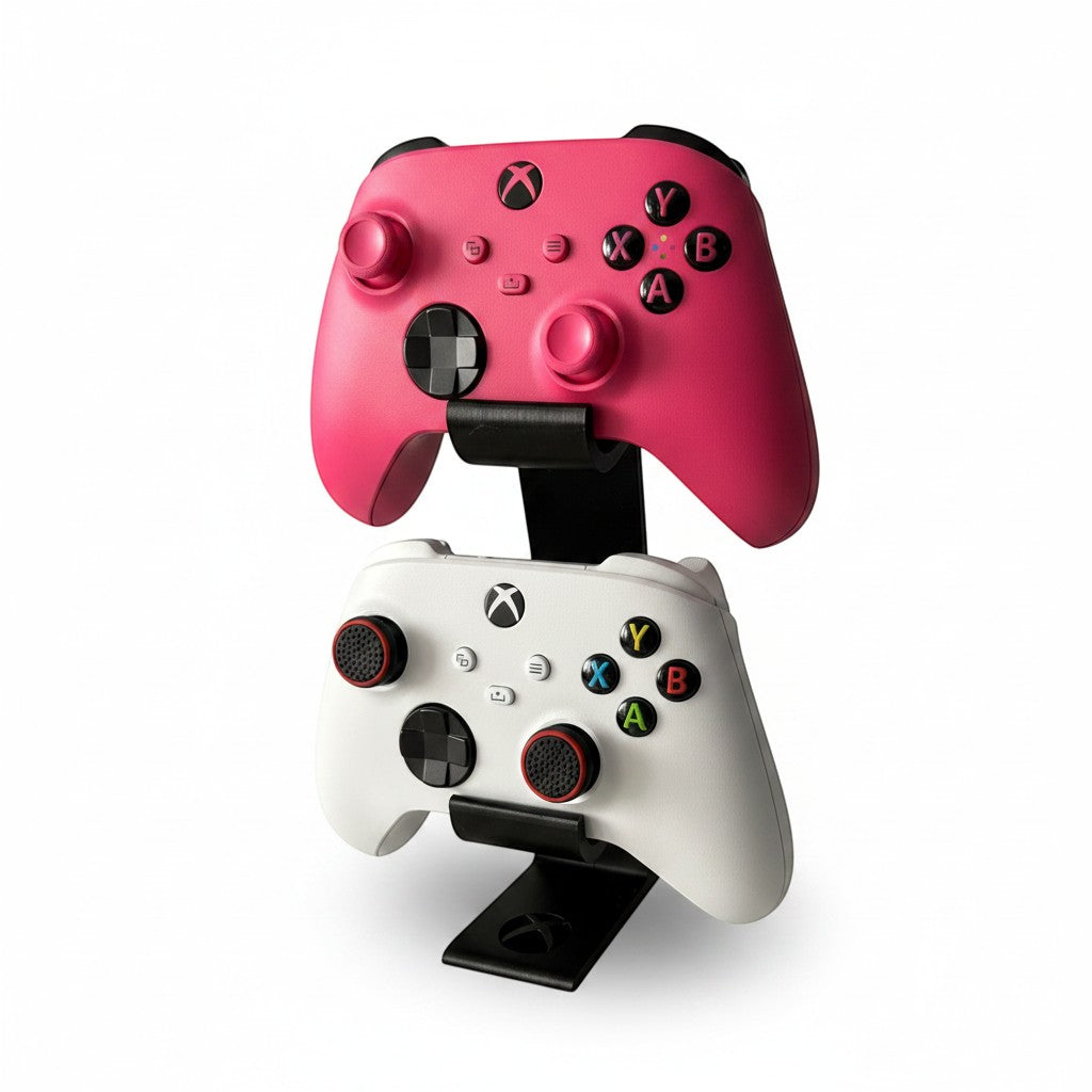 Magicland 3D vertical stand for two Xbox controllers, one pink and one white, on a white background.