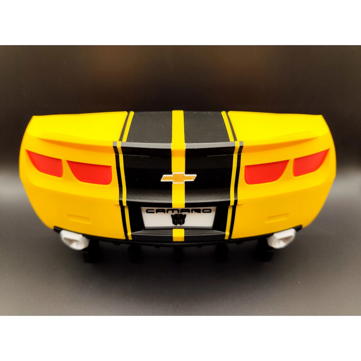 Magicland 3D yellow Chevrolet Camaro rear end keychain holder with black racing stripes and chrome exhaust pipes.