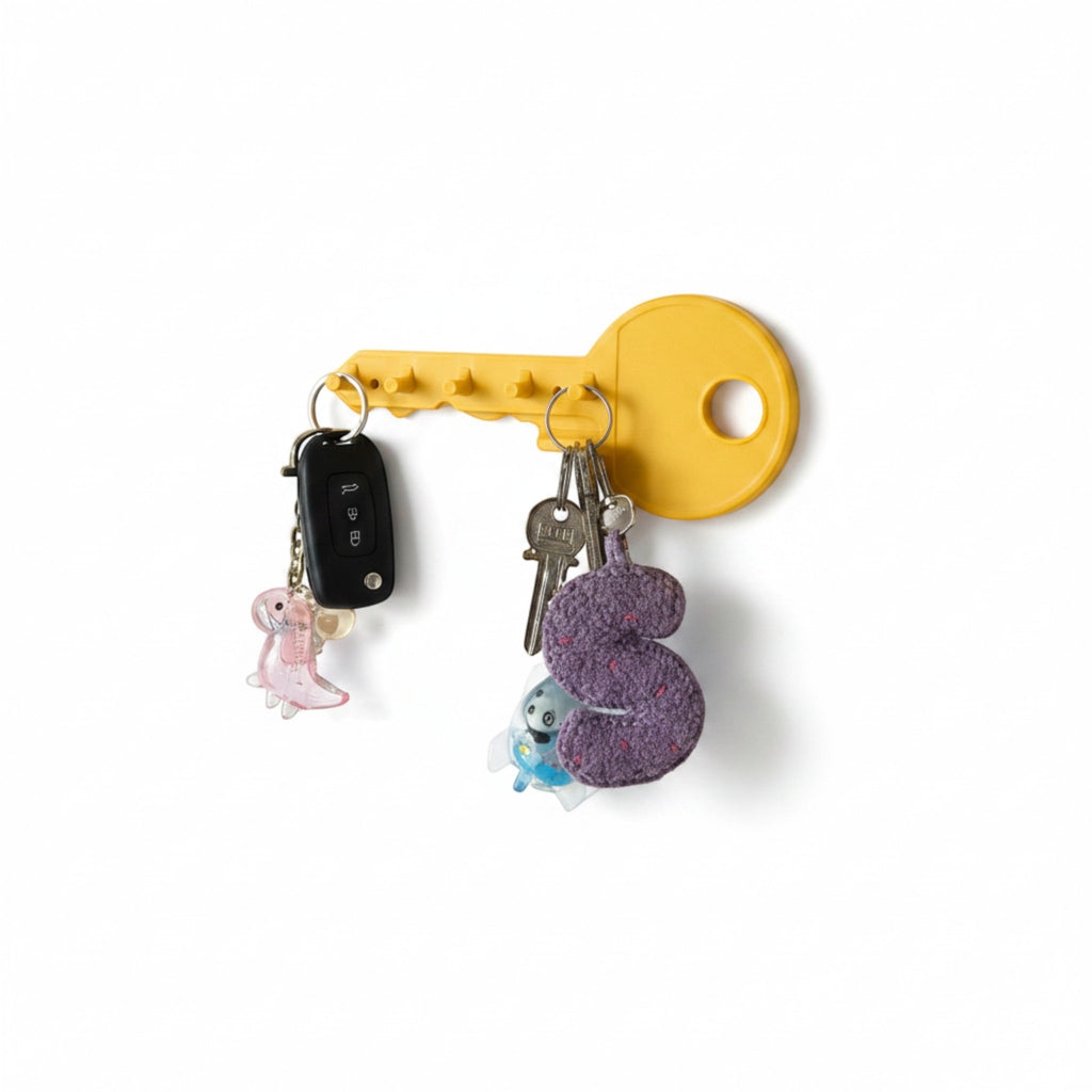 Yellow key-shaped wall key holder by Magicland 3D with 6 hooks holding keys and keychains.
